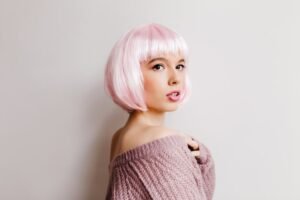 fascinating-lady-pink-periwig-posing-with-serious-face-expression-portrait-cute-girl-peruke-isolated-white-wall_197531-8026